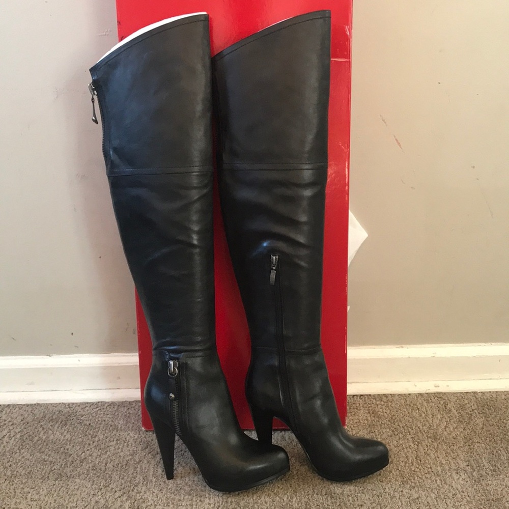 Above the knee black Guess leather boots.